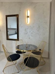 a dining room with a table and chairs and a mirror at Budva house Maja in Budva