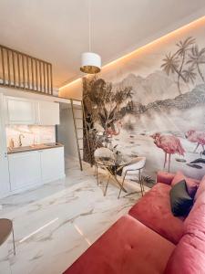 a living room with a large mural of birds on the wall at Art Apartments Warszawska 21 Katowice in Katowice