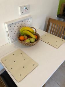 a basket of bananas and other fruit on a table at The Copper Coin in Winford