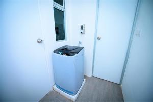a small bathroom with a trash can in a room at Jeff and Ricky Homestay Matang Metrocity in Kuching