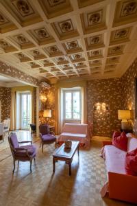 a large living room with a coffered ceiling and a couch at ROMAMOREMIO in Rome