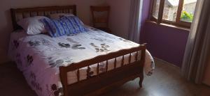 1 dormitorio con 1 cama con marco de madera en Mont Pley, en Esson