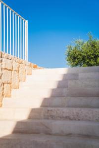 a set of concrete stairs with a fence at Olea Relais in Conversano