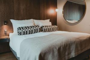 um quarto com uma cama grande e um espelho em Funken Lodge em Longyearbyen