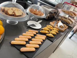 a buffet with a bunch of food on a table at Fiftyfour West Boutique Living in Għarb