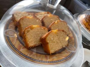 a glass plate with slices of pound cake on it at Fiftyfour West Boutique Living in Għarb