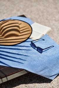 a pair of glasses sitting on top of a blue towel at Hotel Villa Eugenia in Lovran