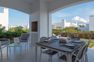 a table with glasses of wine on a patio at Blue Sea Villas by Wonderful Italy in Ostuni