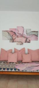 a couch with pink pillows in a room at Apartamentos Can Salas in Cala Figuera