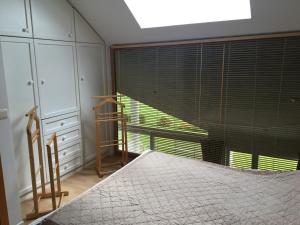 a bedroom with a bed and a large window at Baronheid in Francorchamps