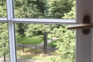 a window with a view of a tree at Smart park view studio in heart of Riga 5 min to Old Town in Riga