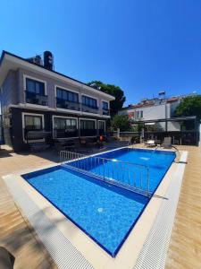 a large swimming pool in front of a house at World Cities Residence in Kemer