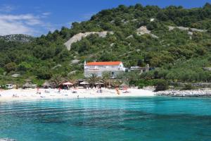 a view of a beach with people on the sand at Rooms by the sea Hvar - 8785 in Hvar