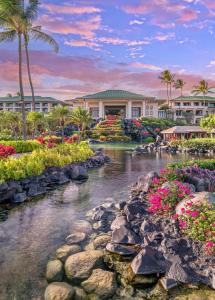 a large garden with flowers in it near a body of water at Grand Hyatt Kauai Resort & Spa in Koloa