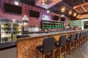 a bar in a restaurant with a bunch of bottles of alcohol at Clarion Inn Asheville Airport in Fletcher