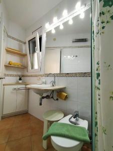 a bathroom with a toilet and a sink at La Caseta in Tamariu