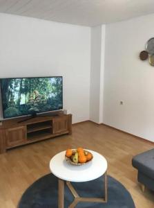 a living room with a table in front of a tv at Monteurwohnung Heilbronn nahe Neckarsulm in Heilbronn