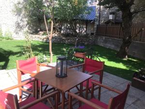 a table and chairs with a candle on a patio at Hotel Saueth in Tredós