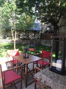 a wooden table and chairs in a yard at Hotel Saueth in Tredós