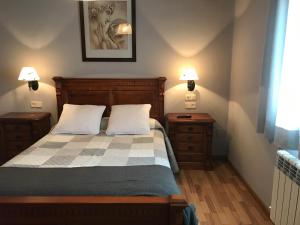 a bedroom with a bed and two night stands at Hotel Saueth in Tredós