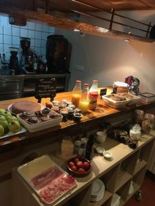 a kitchen with a counter with different types of food at Hotel Saueth in Tredós