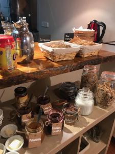 a shelf filled with jars of food and other ingredients at Hotel Saueth in Tredós