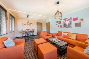 a waiting room with orange couches and a table at The Mex - El Sombrero in Arnstadt