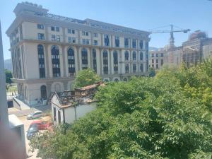 a large white building with a crane in the background at Skopje Apartment in Skopje