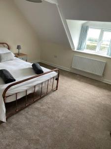 a bedroom with a bed and a large window at Tweed Cottage 4 Fenton Hill in Wooler
