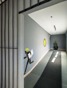 a wall mural of a person running with an umbrella at Rooms Inc BTC Bandung in Bandung