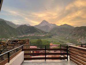 a balcony with a view of a mountain valley at Capra Hotel Kazbegi in Kazbegi