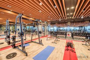 a gym with treadmills and exercise equipment at Classy 1BR at Bayz by Danube Business Bay by Deluxe Holiday Homes in Dubai