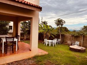 a patio with a table and chairs on the grass at Aloe 40 in Burgersfort