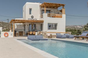 a villa with a swimming pool in front of a house at Villa Armelina in Plaka