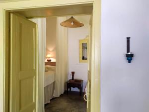 a hallway with a door leading to a bedroom at Grandpa's Traditional Guesthouse in Amorgos