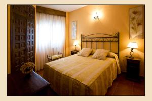 a bedroom with a bed and two lamps and a window at Casa Tia Paula in Carrión de los Condes