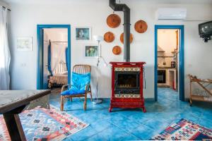 a living room with a fireplace and a blue tile floor at La Ripa - Appartamento Il Fienile in San Gimignano