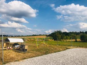 a field with a tent and a kite in the grass at Le Gîte de Golette in Mettet