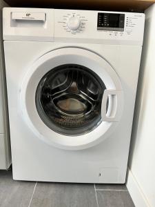a white washing machine with its door open at Logia in Ploërmel