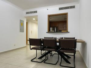 a dining room with a table and chairs at [METRO] Premium Location Lovely 2 Bedroom In JLT in Dubai