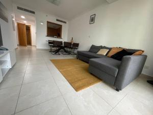 a living room with a couch and a table at [METRO] Premium Location Lovely 2 Bedroom In JLT in Dubai