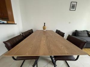 a wooden dining room table with chairs and a couch at [METRO] Premium Location Lovely 2 Bedroom In JLT in Dubai