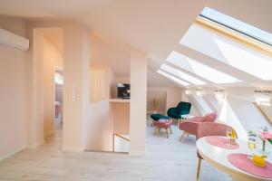 a living room with a skylight and a table and chairs at Harmony Boutique Villa in Siófok