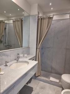 a bathroom with a sink and a shower and a toilet at Hotel Miramare - Adults Only in Trieste