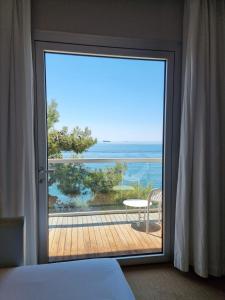 a bedroom with a view of the ocean through a sliding glass door at Hotel Miramare - Adults Only in Trieste