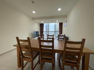 a dining room with a wooden table and chairs at METRO Premium Location Spacious 2 Bedroom Apartment Right Next to the Metro in Dubai