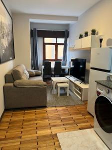 a living room with a couch and a table at MSuites Viveiro in Viveiro +50 photos
