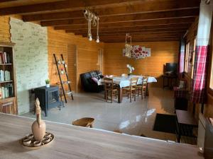 a living room with a table and a dining room at CHALET LE MONTEBELLO in Bazeilles