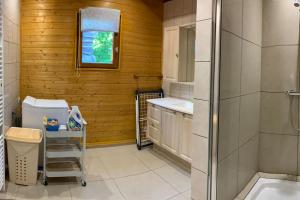 a bathroom with a toilet and a sink and a shower at CHALET LE MONTEBELLO in Bazeilles