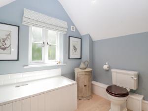 a bathroom with a toilet and a window at Number 29 in Malvern Link